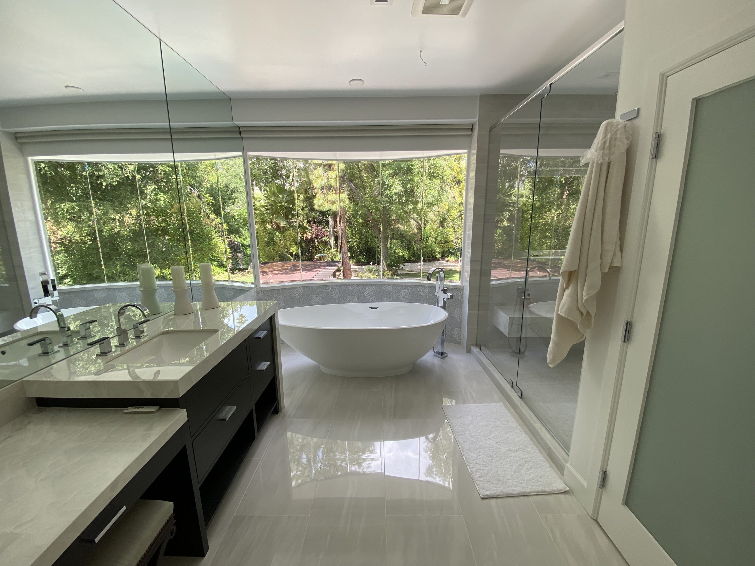 Master bathroom upgrade with glass shower enclosure, double sink vanity, and modern accents