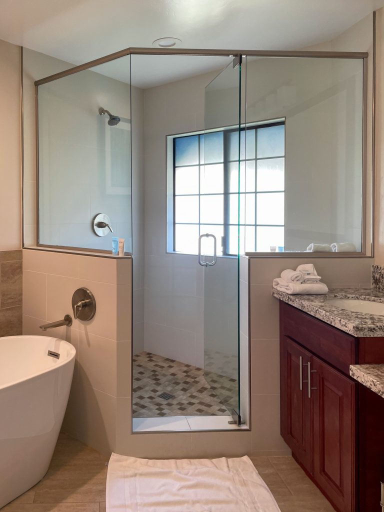 Master bathroom remodel in Los Angeles featuring a frameless glass shower enclosure, freestanding soaking tub, and custom cherry wood vanity with granite countertop — by SK Home Designs & Remodeling